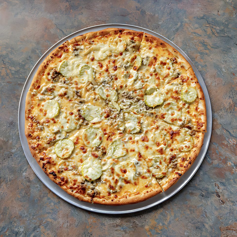 D-Ray's Pizzeria's whole pickle pizza, topped with melted cheese and sliced pickles on a metal tray.